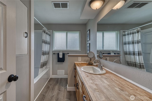 full bathroom with vanity, shower / bath combination with curtain, and visible vents