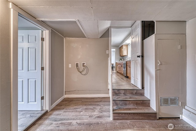 interior space featuring visible vents, baseboards, and wood finished floors