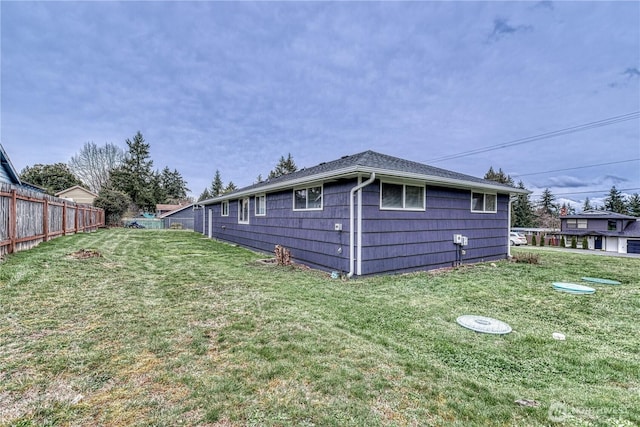 back of house with a yard and fence