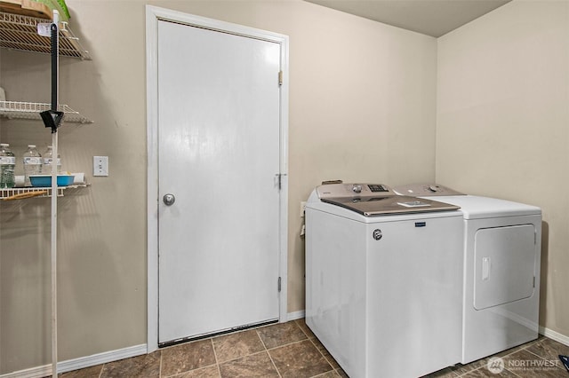 laundry room with washer and dryer, baseboards, and laundry area