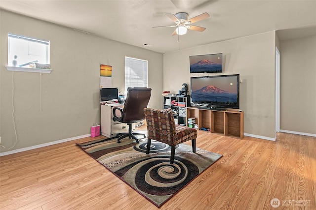 office space featuring a ceiling fan, wood finished floors, and baseboards