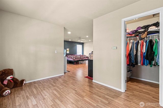 interior space featuring recessed lighting, baseboards, and wood finished floors