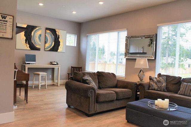 living area with recessed lighting, light wood-style flooring, and baseboards