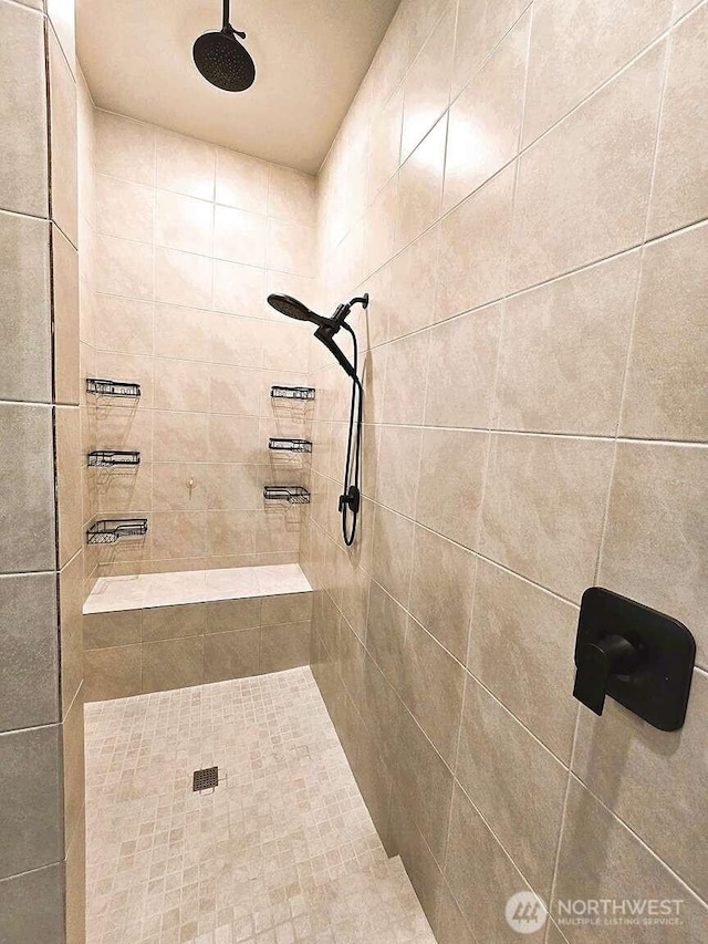 bathroom with tiled shower