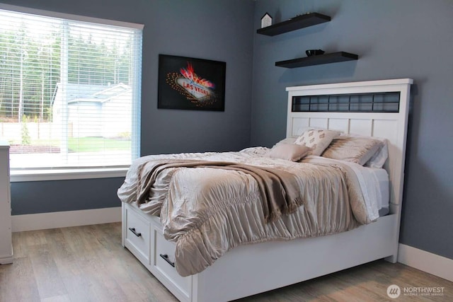 bedroom with baseboards and light wood-type flooring