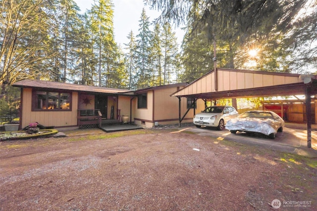 view of front of house featuring a carport, covered porch, and driveway