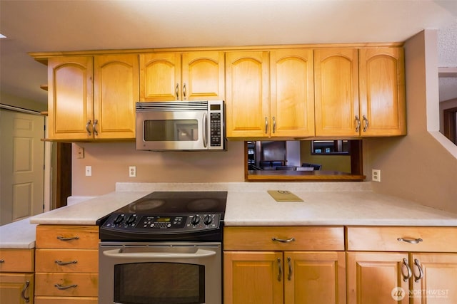 kitchen with stainless steel appliances and light countertops