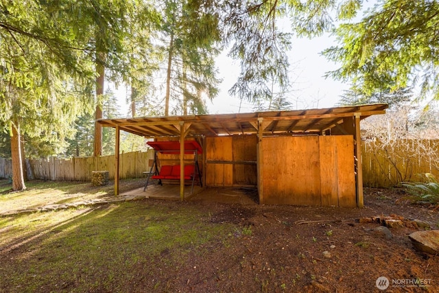 view of pole building with a carport and fence