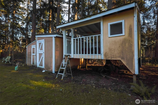 view of property exterior with an outdoor structure