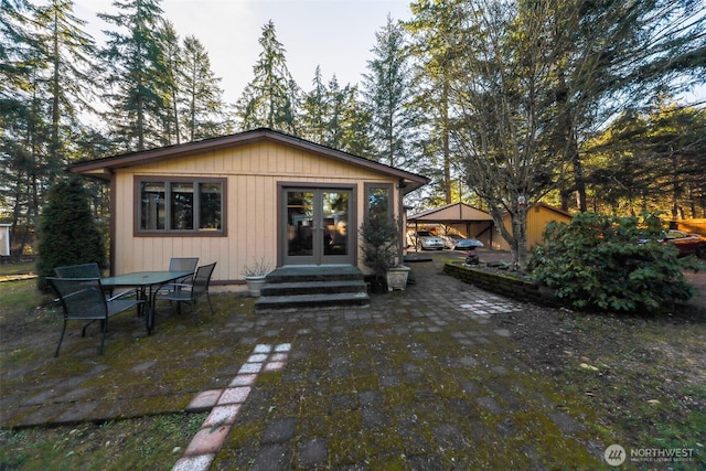 back of house featuring entry steps and a patio