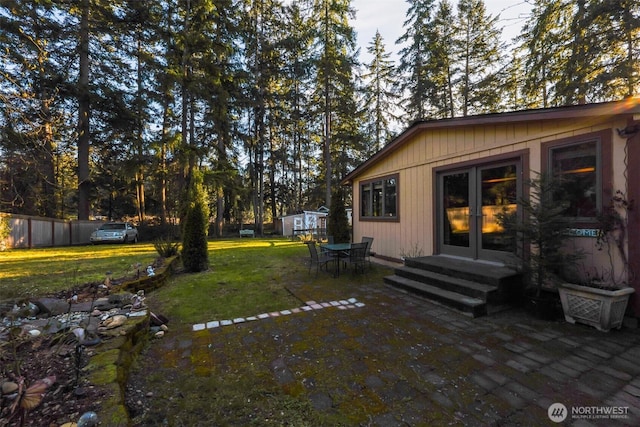 view of yard featuring french doors, a patio, and fence