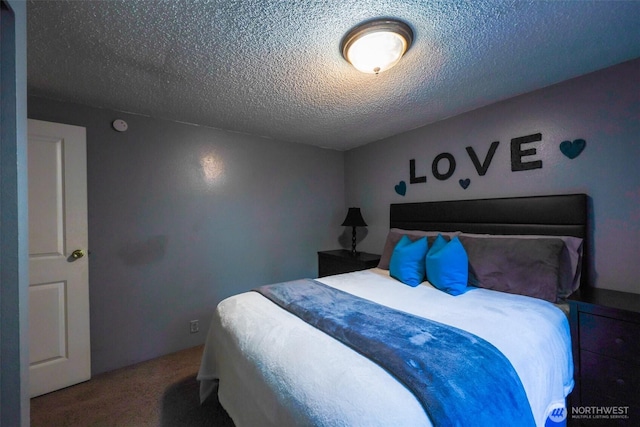 carpeted bedroom with a textured ceiling