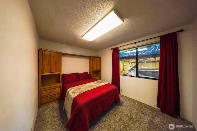 bedroom featuring carpet and a textured ceiling