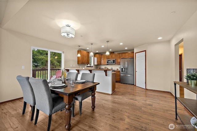 dining space with recessed lighting, wood finished floors, and baseboards