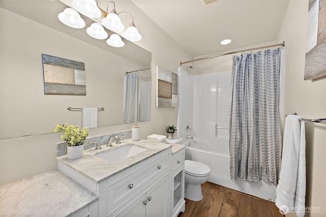 bathroom featuring vanity, shower / tub combo, toilet, and wood finished floors