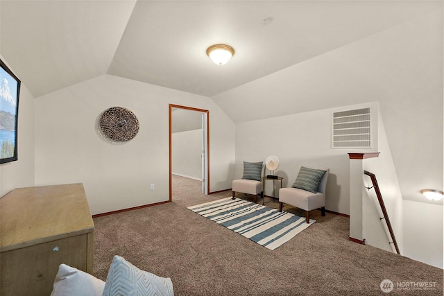 living area with visible vents, an upstairs landing, carpet flooring, and vaulted ceiling