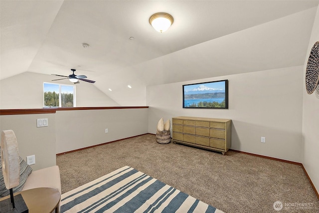 living area featuring baseboards, carpet, ceiling fan, and vaulted ceiling