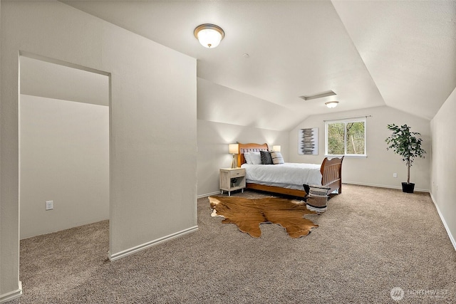 bedroom featuring baseboards, lofted ceiling, and carpet floors