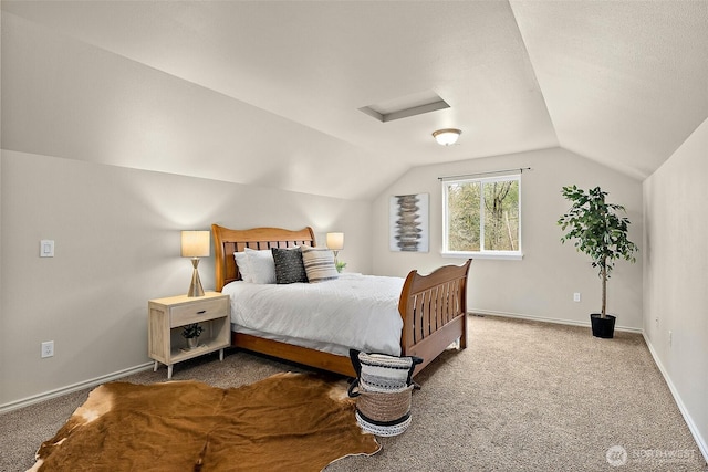 carpeted bedroom with attic access, baseboards, and vaulted ceiling