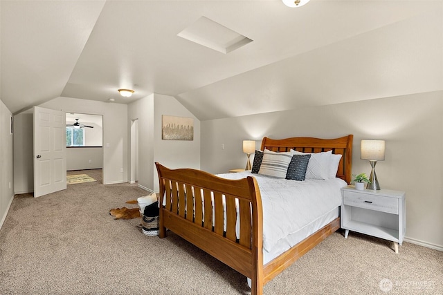 carpeted bedroom with baseboards and lofted ceiling