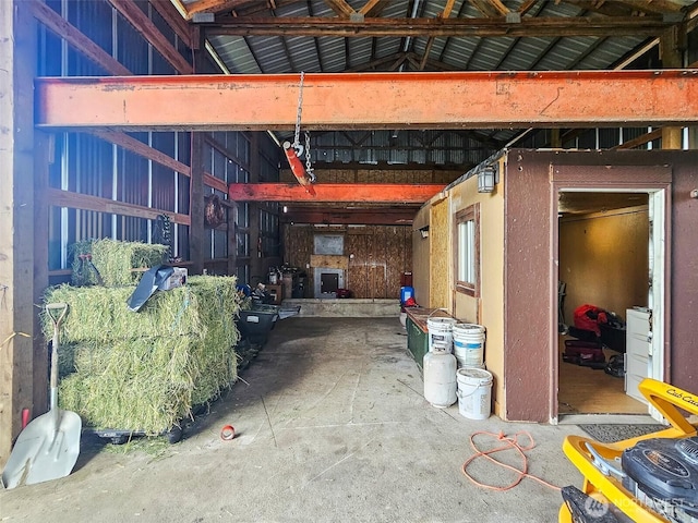 miscellaneous room featuring lofted ceiling and a garage