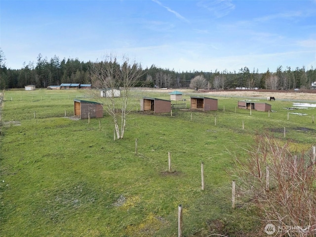 view of yard featuring a rural view and an outdoor structure