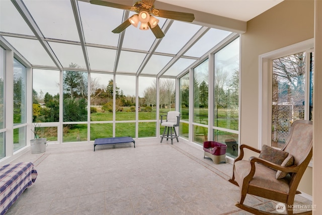 sunroom featuring ceiling fan