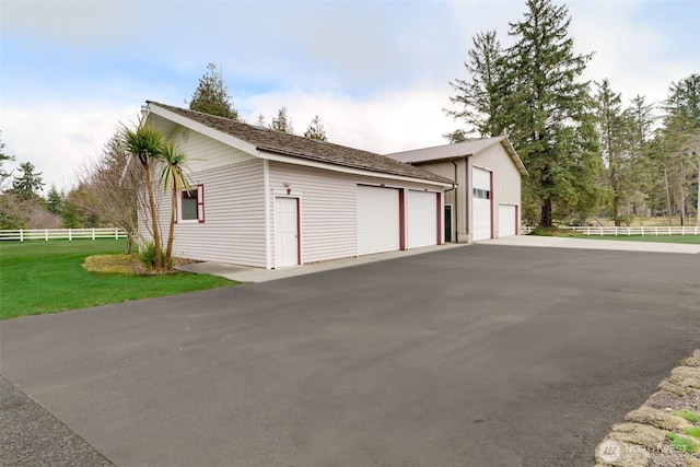 detached garage featuring fence