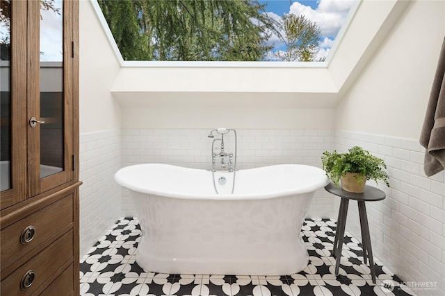 3430 126th Ave NE, Bellevue, WA 98005 - full bath with a wainscoted wall, a freestanding bath, tile walls, and healthy amount of natural light