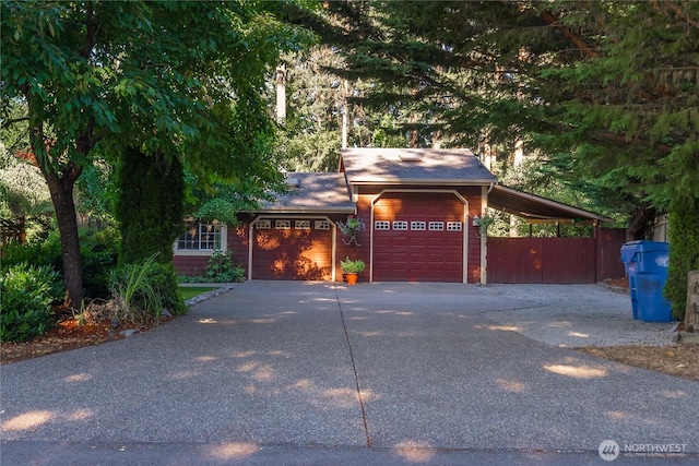 exterior space featuring a garage, a carport, and driveway