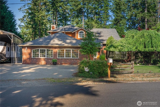 view of front of property featuring brick siding, roof with shingles, and a chimney