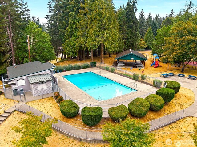 community pool with a patio and fence