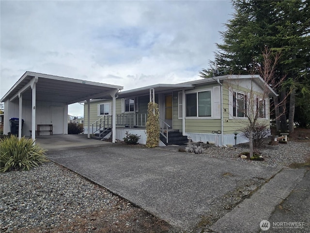 manufactured / mobile home with a carport and driveway