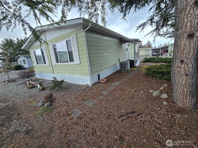 view of side of home with central AC unit