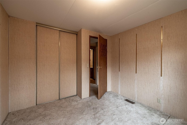 unfurnished bedroom featuring visible vents and a closet