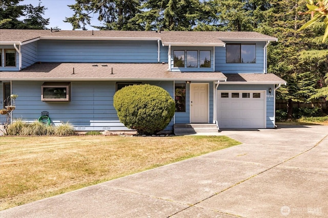1234 NW Lanyard Loop Unit 1, Oak Harbor, WA 98277 - view of front facade with concrete driveway, an attached garage, and roof with shingles