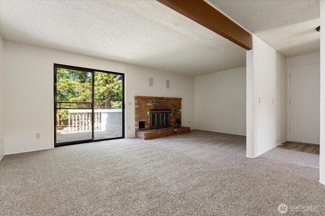 1234 NW Lanyard Loop Unit 1, Oak Harbor, WA 98277 - unfurnished living room with carpet, a textured ceiling, and a brick fireplace