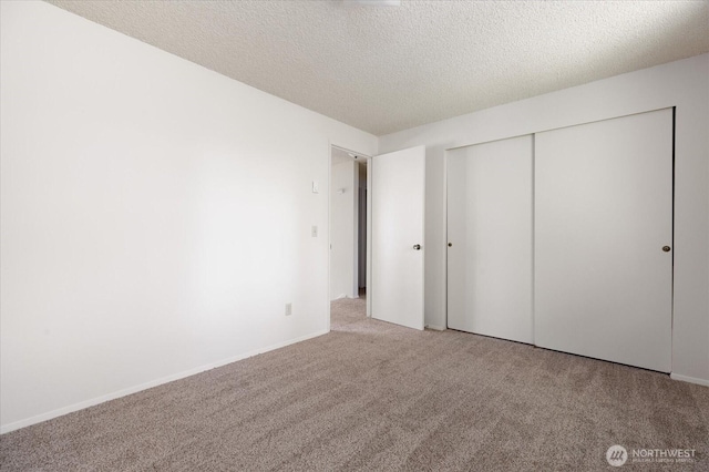 1234 NW Lanyard Loop Unit 1, Oak Harbor, WA 98277 - unfurnished bedroom with carpet flooring, a textured ceiling, and a closet