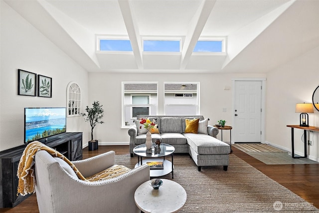 living room with a skylight, baseboards, beam ceiling, and wood finished floors