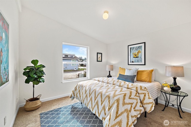 bedroom with baseboards, lofted ceiling, and carpet flooring