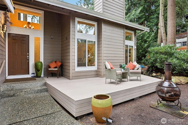 wooden terrace featuring an outdoor fire pit