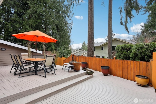 deck featuring outdoor dining space and fence