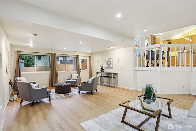 living room featuring recessed lighting, baseboards, and wood finished floors