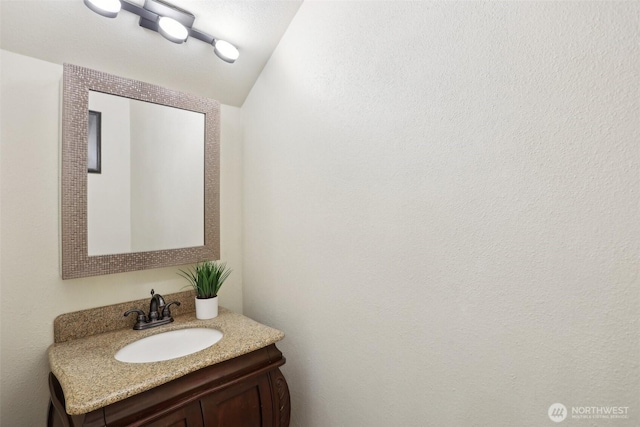 bathroom with vanity and vaulted ceiling