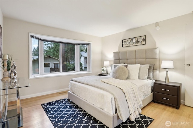 bedroom featuring baseboards and light wood-style flooring