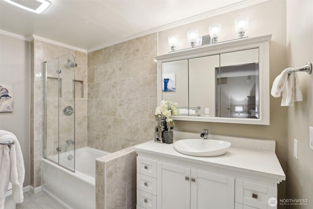 bathroom featuring combined bath / shower with glass door, vanity, and ornamental molding