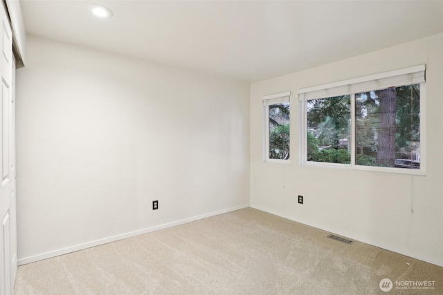 unfurnished room with recessed lighting, visible vents, carpet flooring, and baseboards