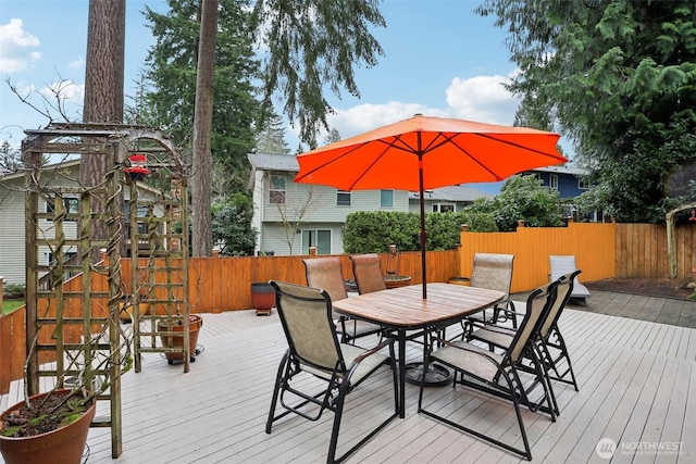 wooden deck featuring outdoor dining space and fence