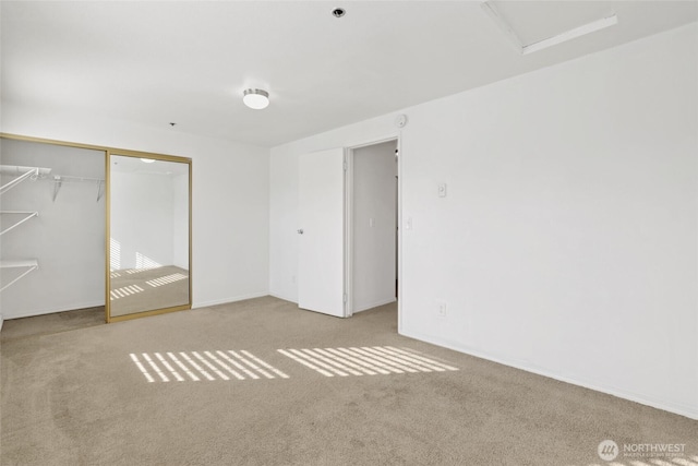 unfurnished bedroom with a closet and carpet