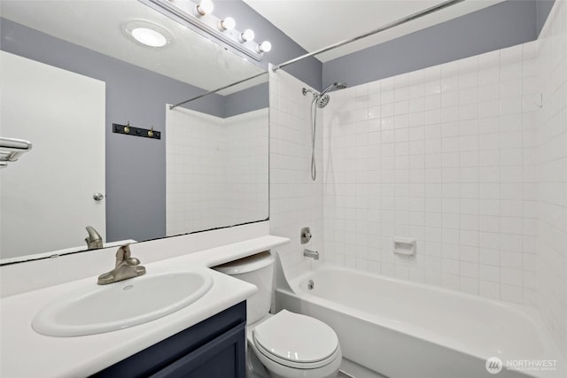 bathroom featuring toilet, vanity, and  shower combination